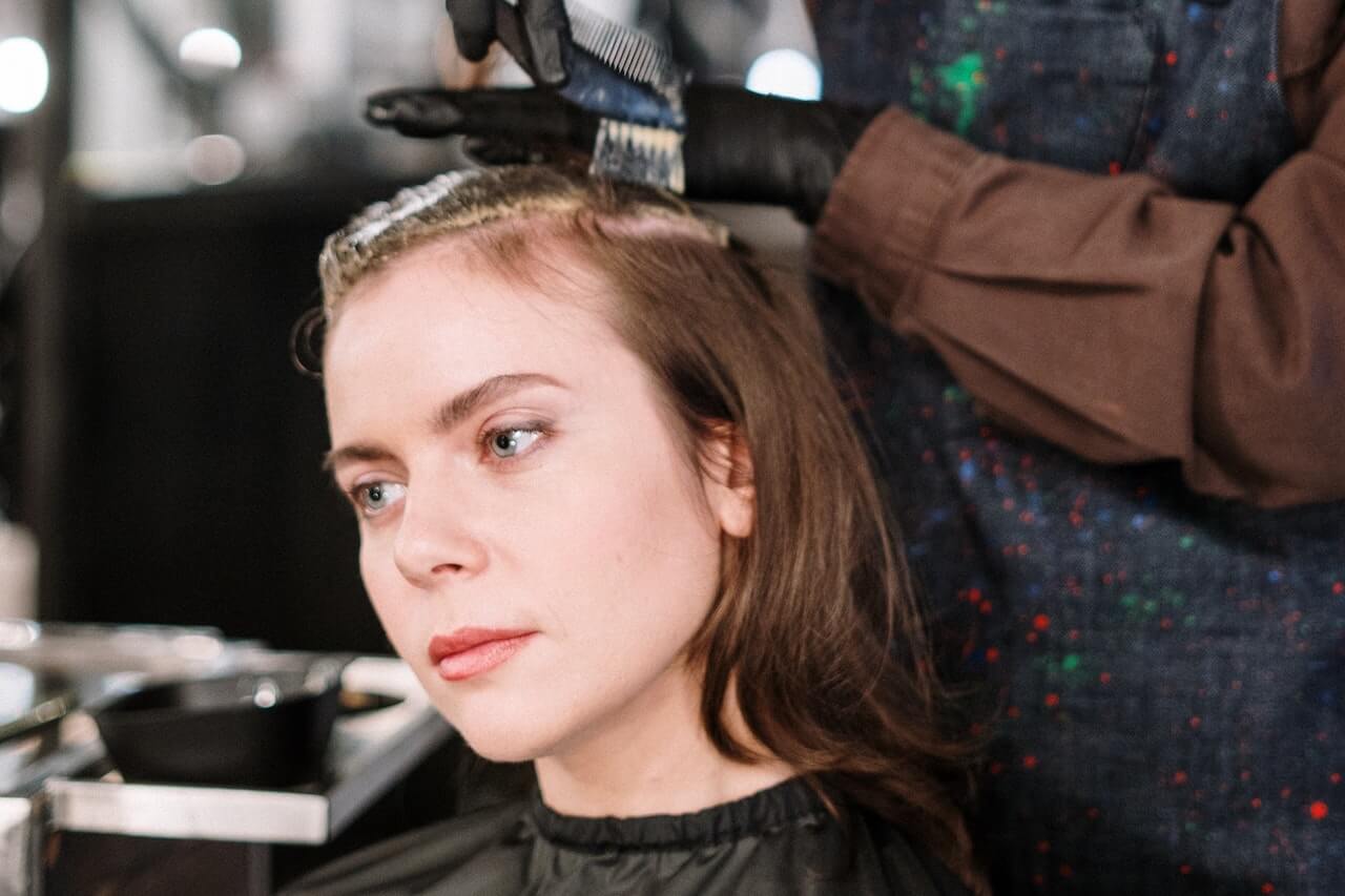 Woman getting hair dyed at the salon