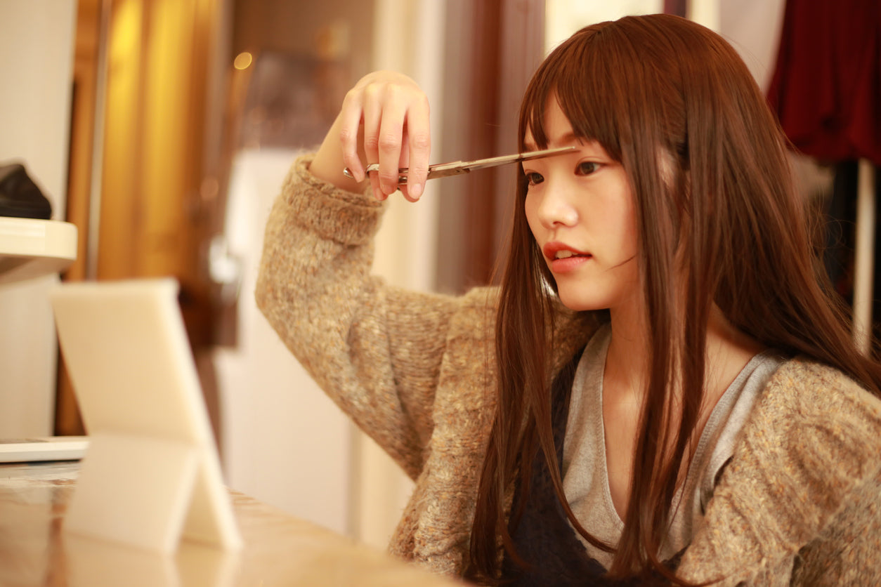 woman cutting her bangs