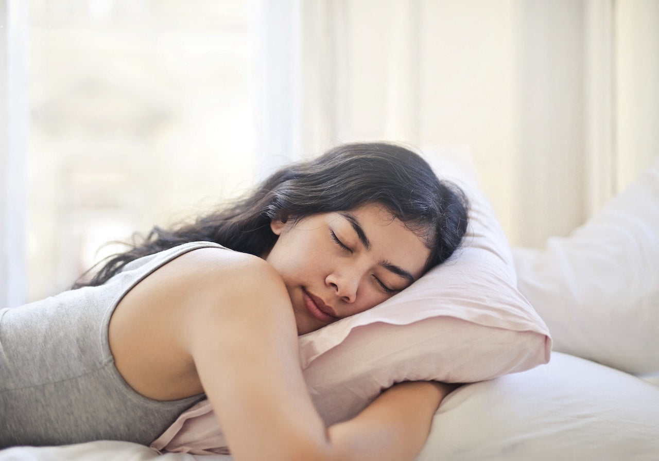 A Hairstylist Tells Us If It's Good to Sleep With Your Hair Up or Down