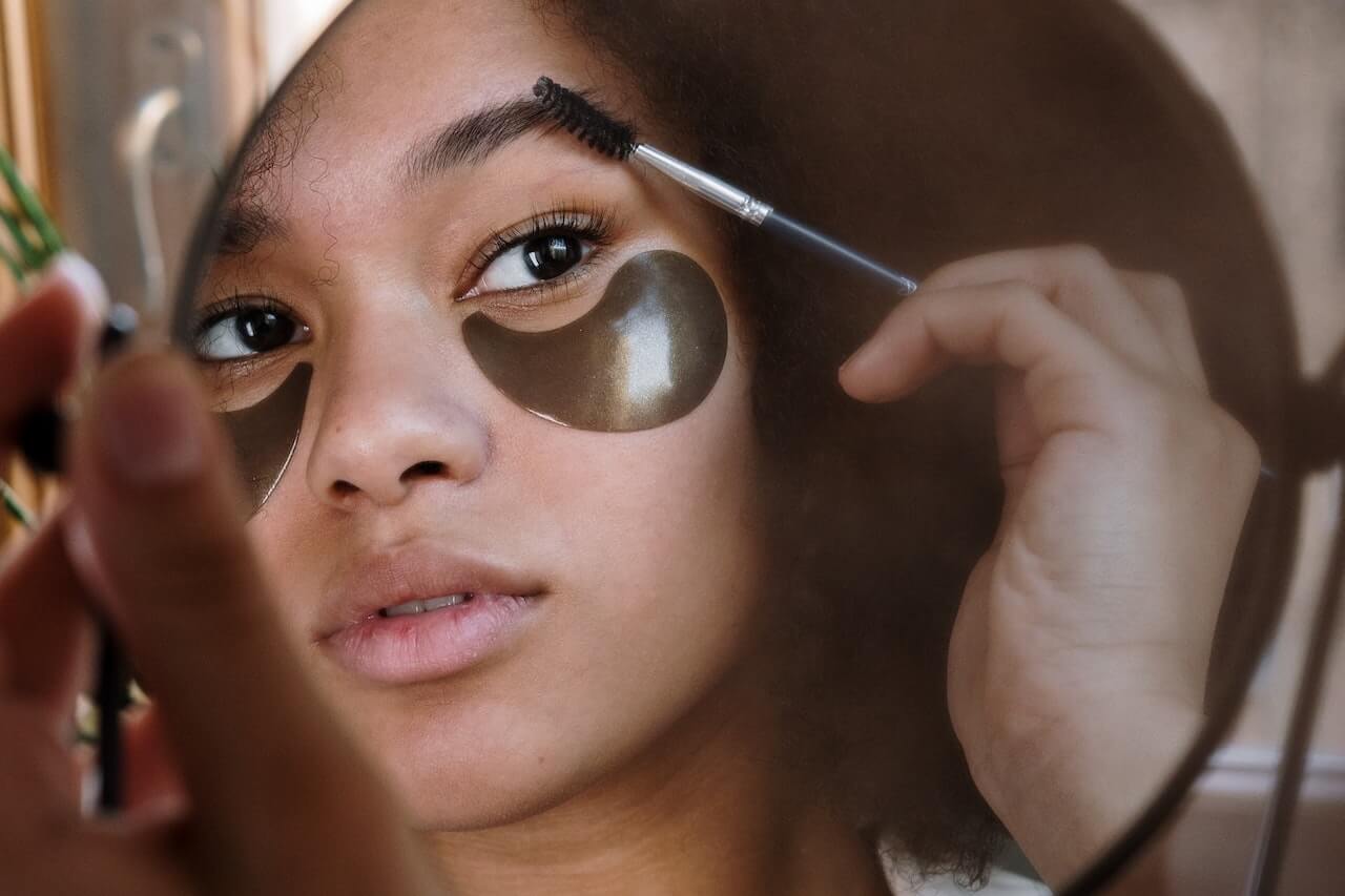 Woman brushing eyebrows
