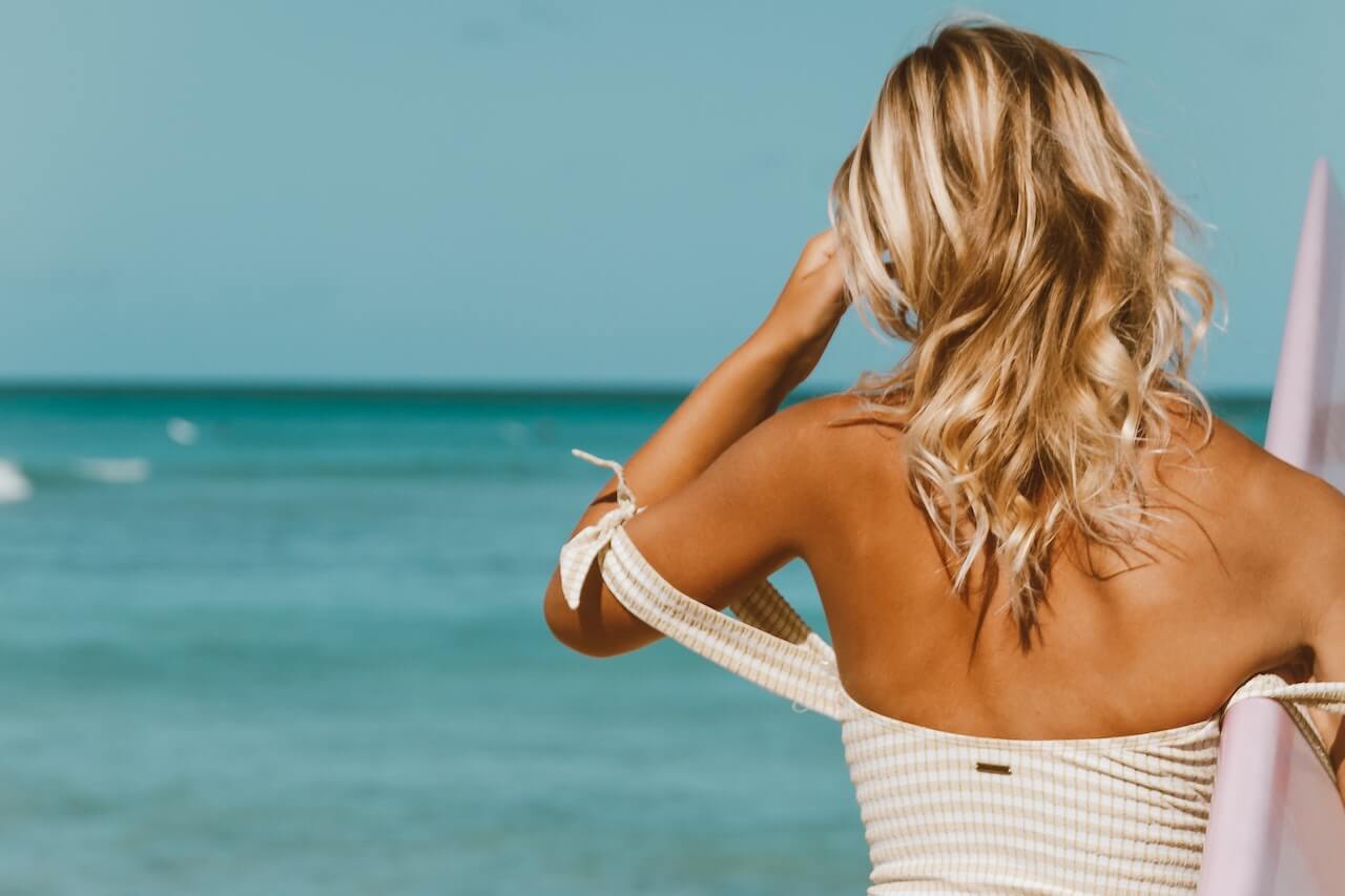 Blonde surfer on beach