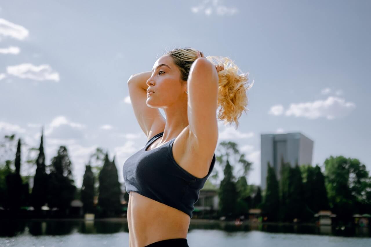 Woman tying her hair up before exercising
