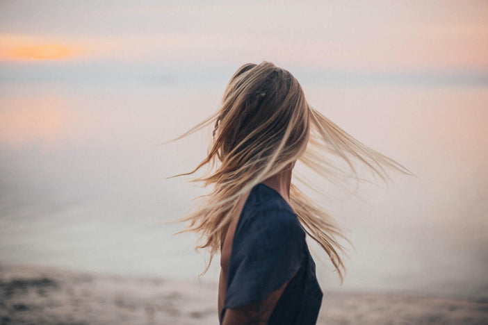 Woman with blonde hair at sunset