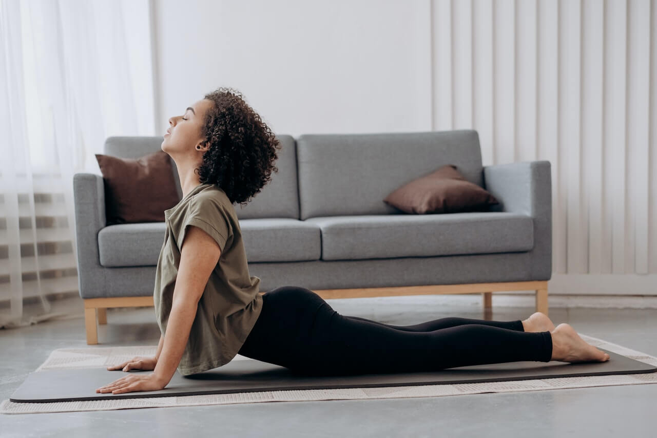 Woman doing yoga in her home