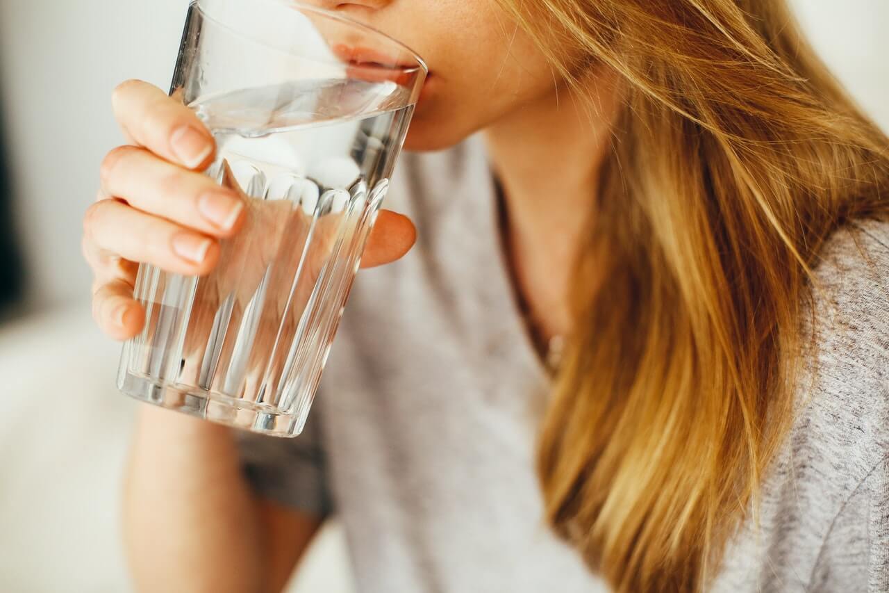 Blonde woman drinking glass of water