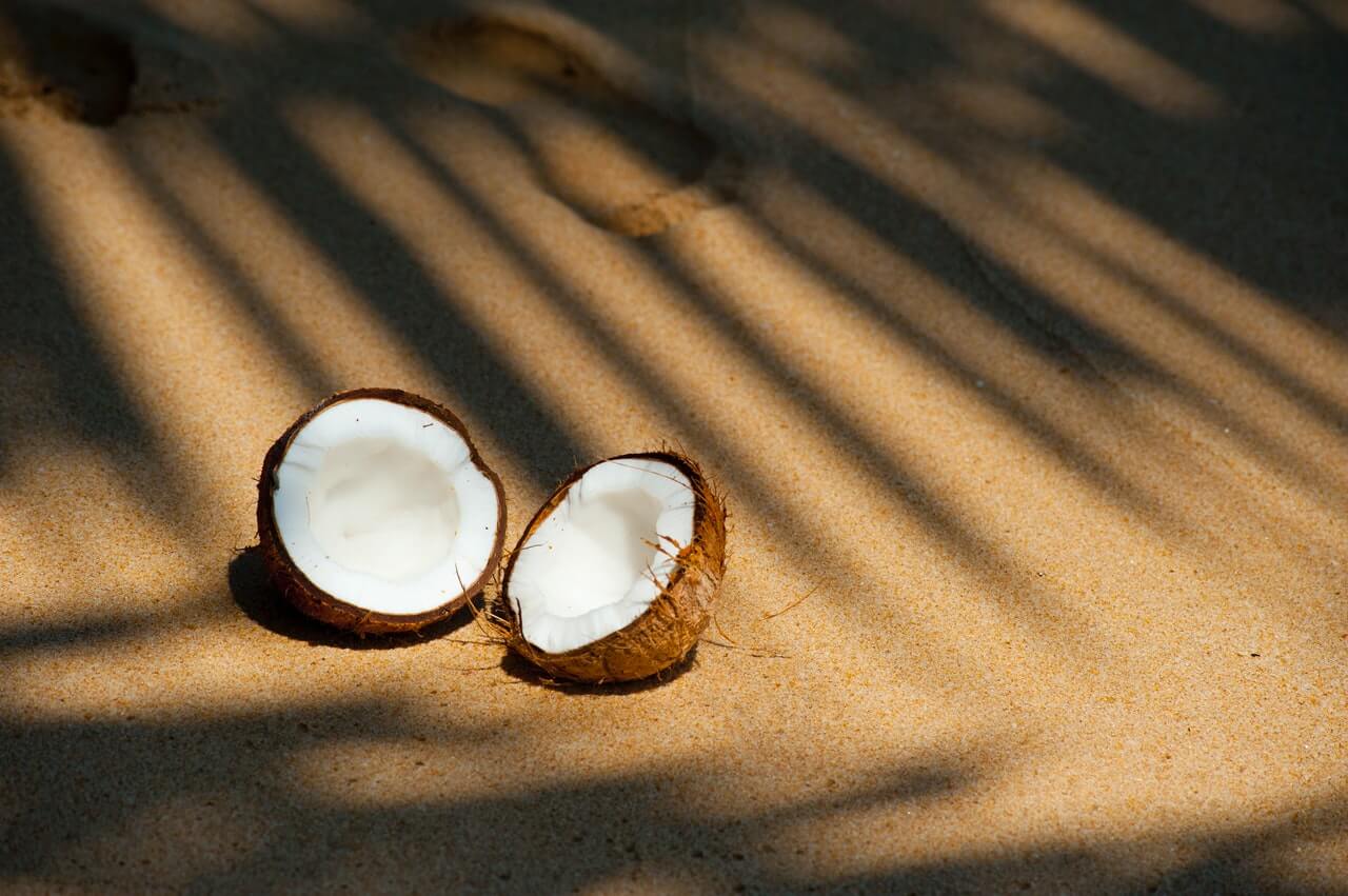 Coconut cut in half on the beach