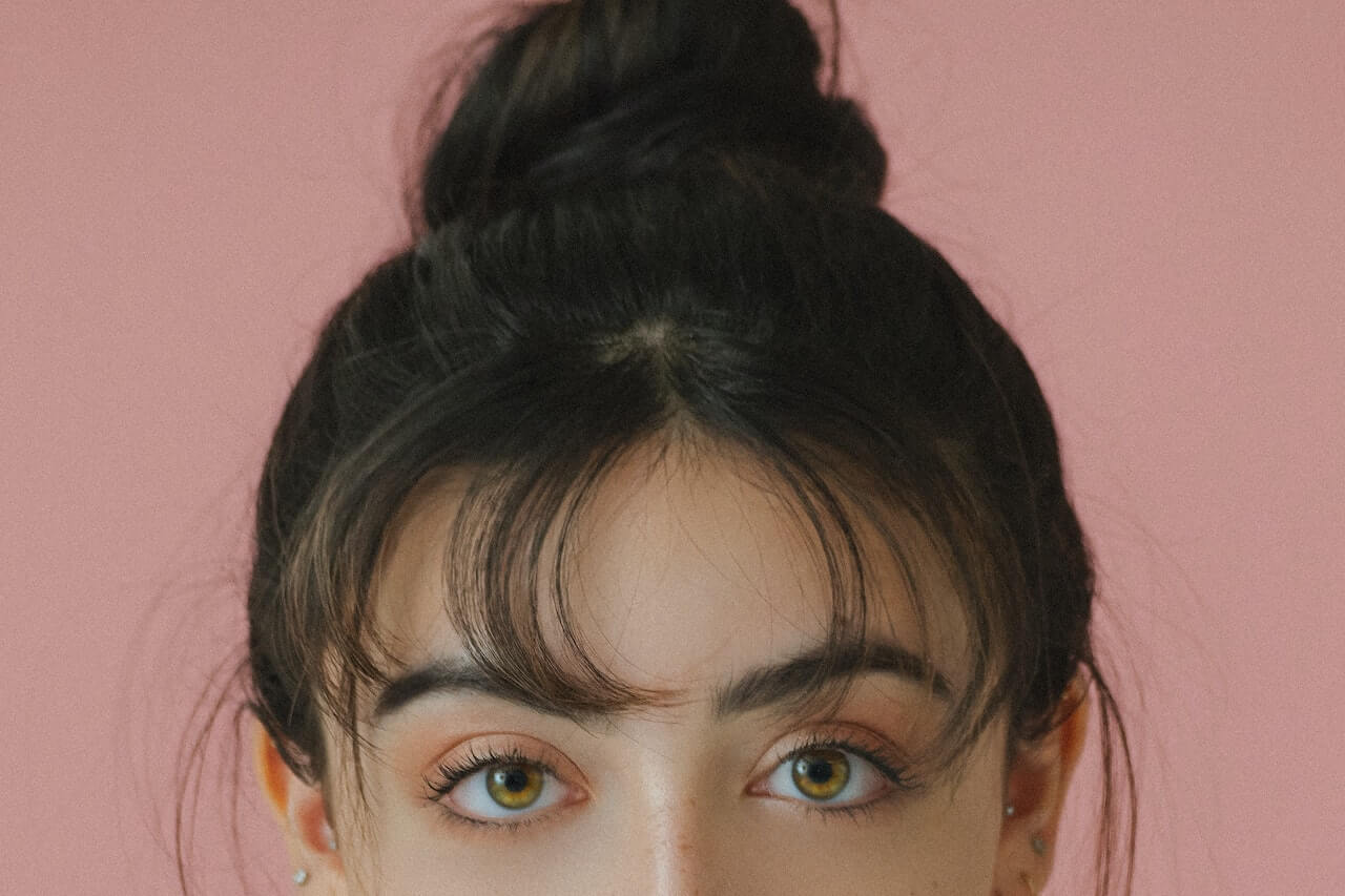 Woman with bangs looking at the camera