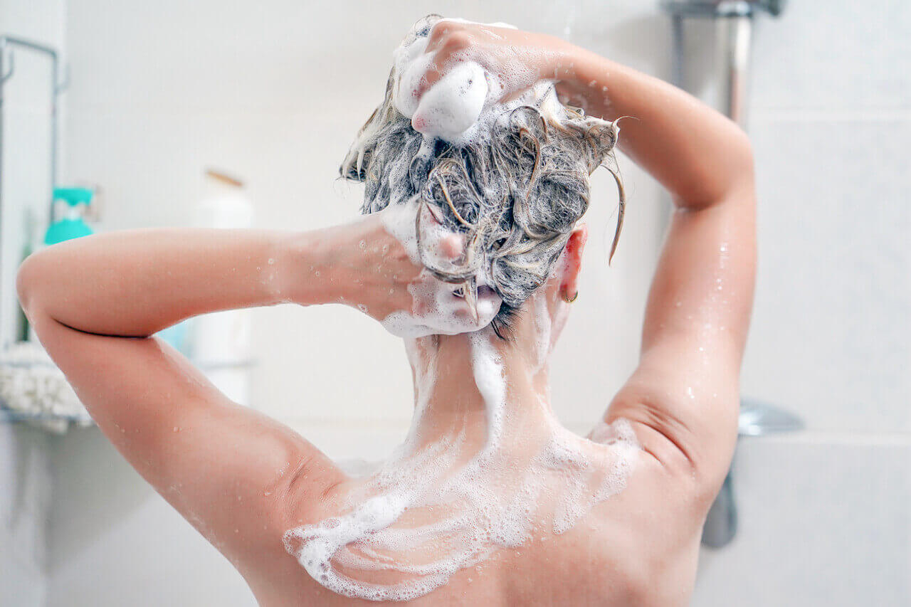 Woman washing hair in the shower