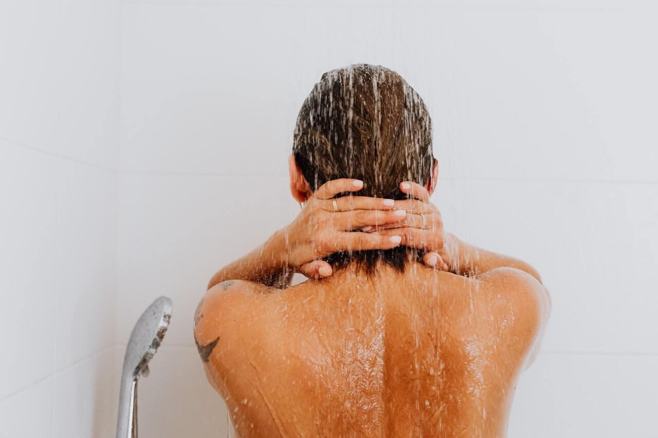 Woman washing hair in shower