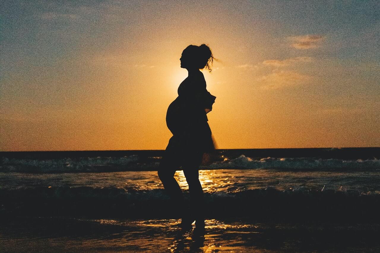 Pregnant woman on beach