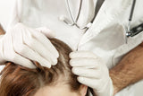 Doctor examining patient's hair