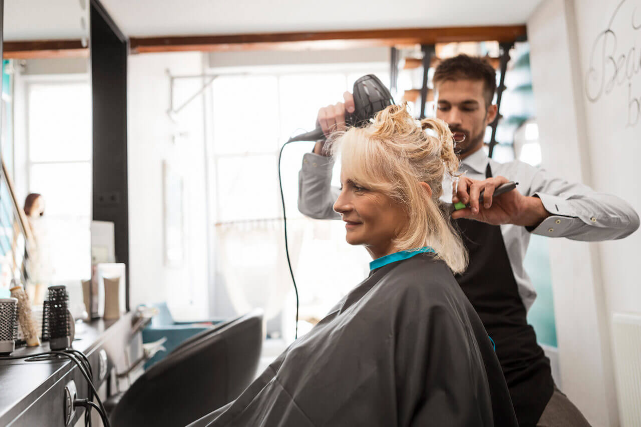 Woman getting hair done at salon