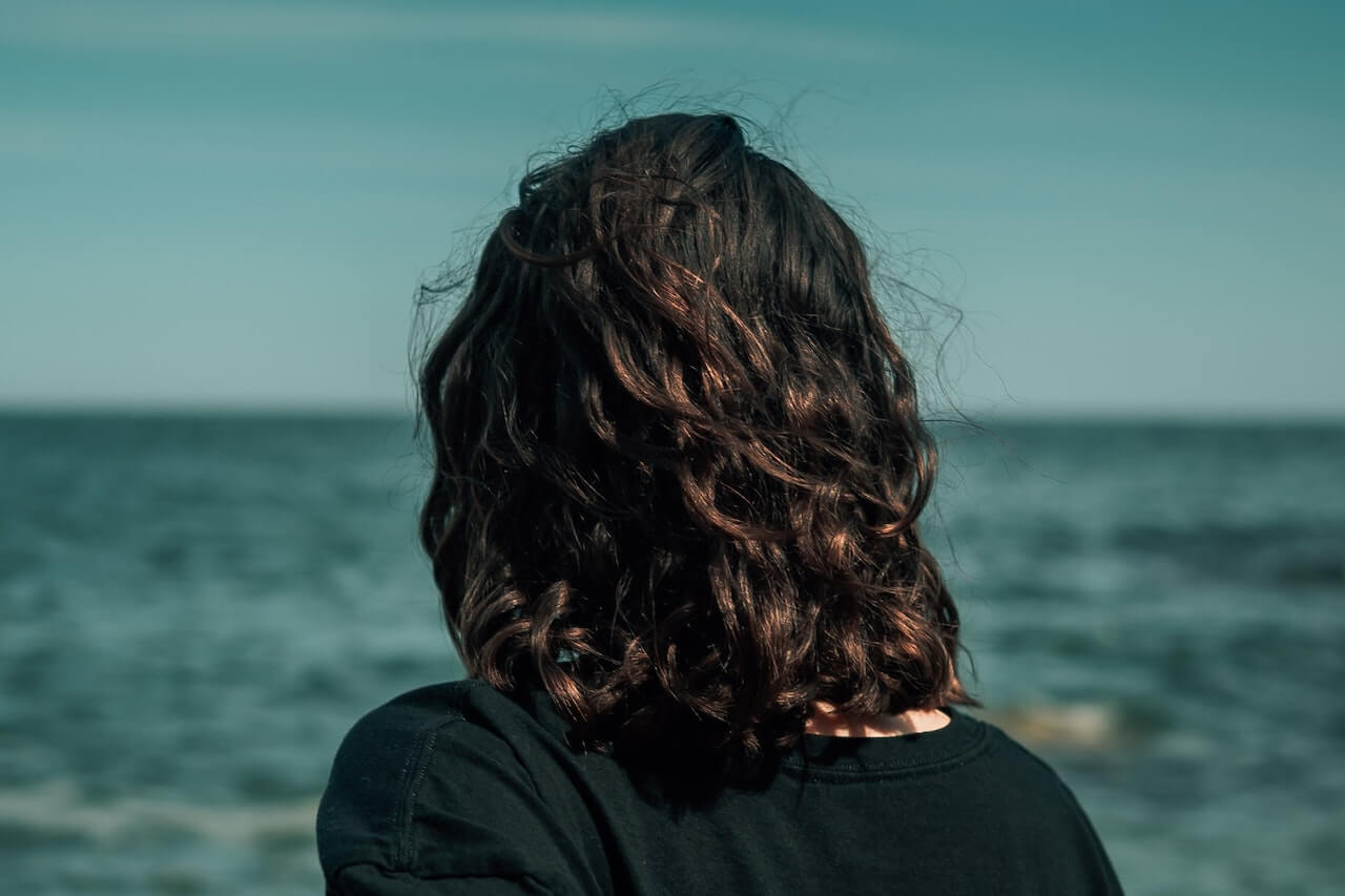 Woman with brown hair at the beach