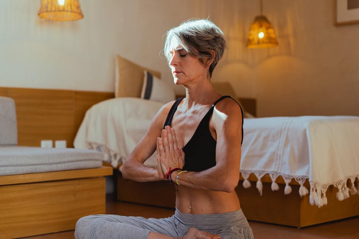 Woman with gray hair doing yoga