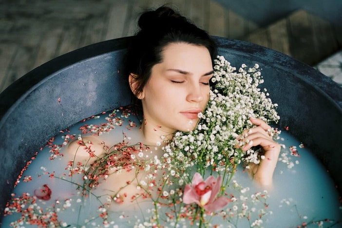 Woman in bathtub with flowers