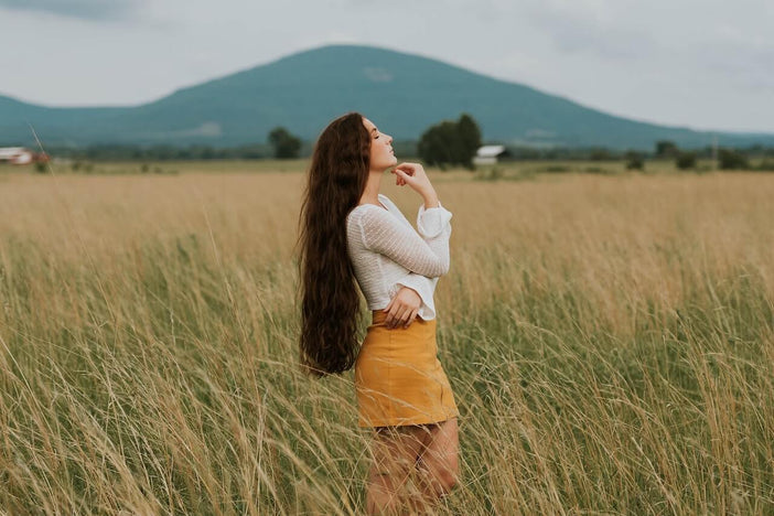 Woman with long hair standing in a field