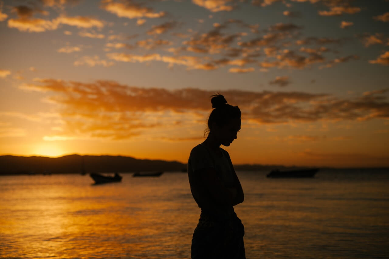 woman at a lake at sunset 