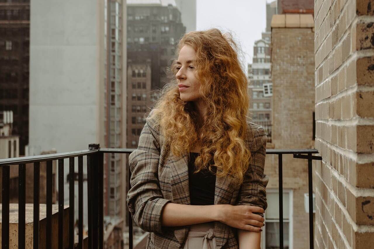 Woman standing on fire escape