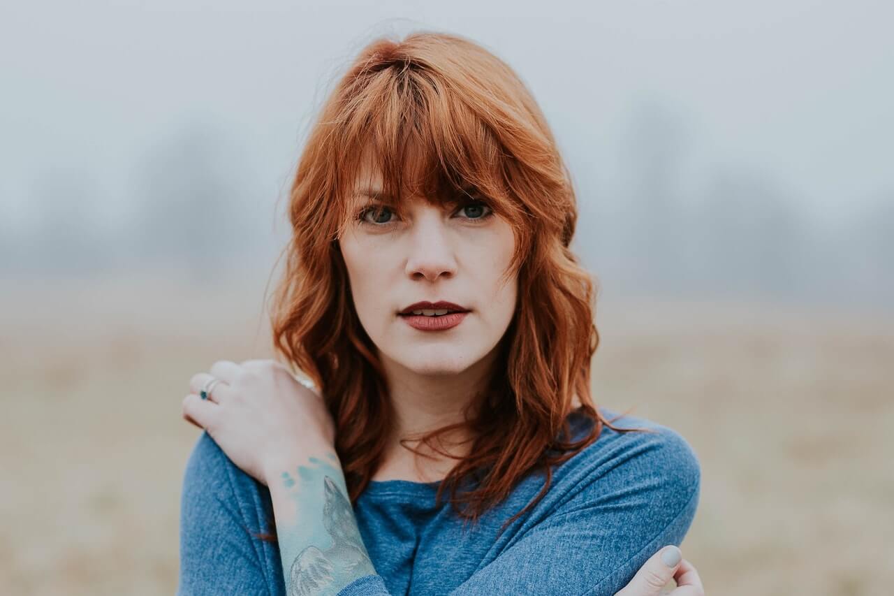Woman with red hair looking at the camera