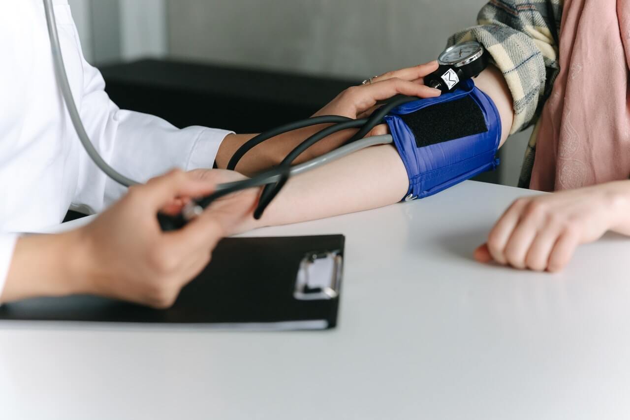 Doctor checking someone's blood pressure