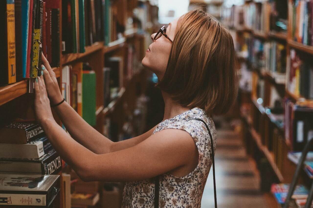 Woman looking at books in the library