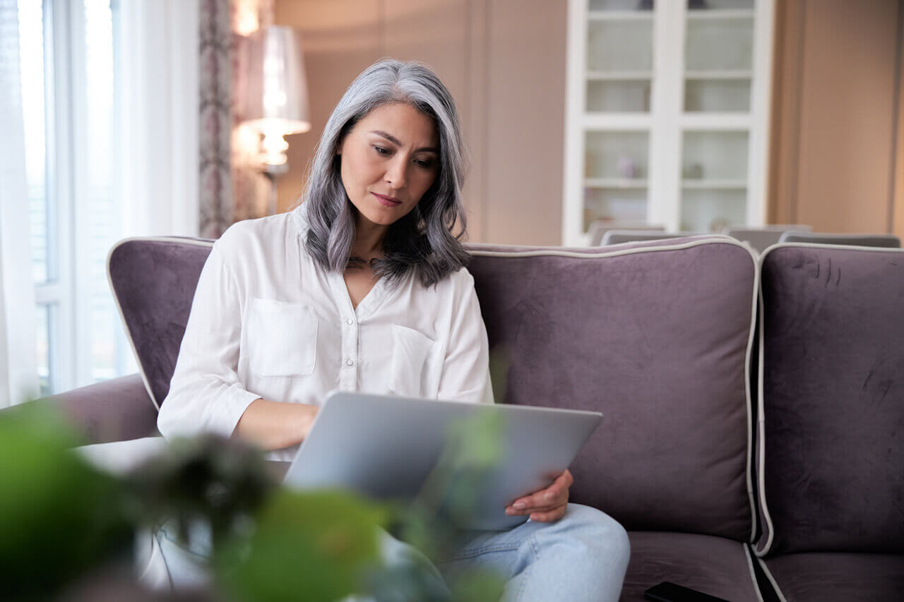 Woman with gray hair on a laptop