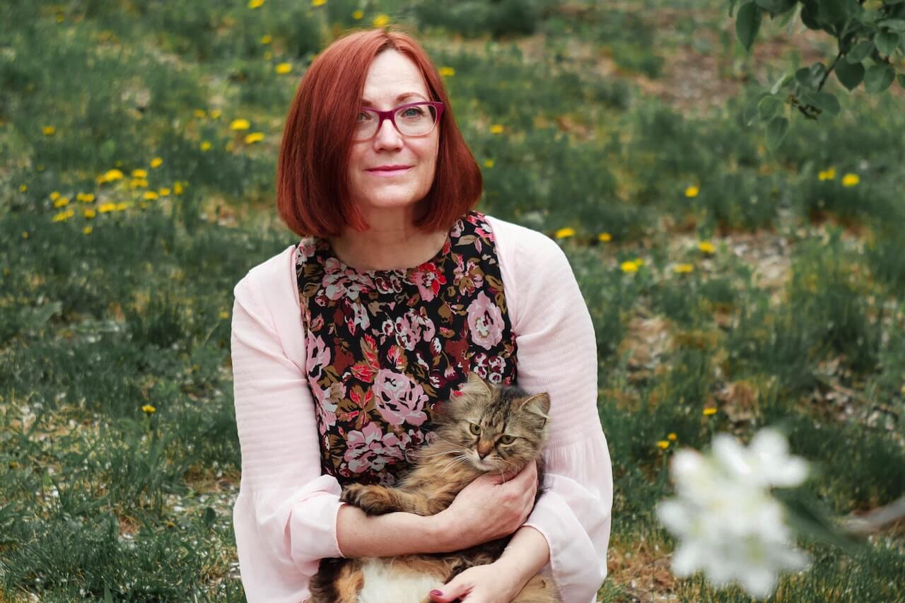 Woman in garden with cat