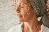 woman with curly hair and a scarf in her hair