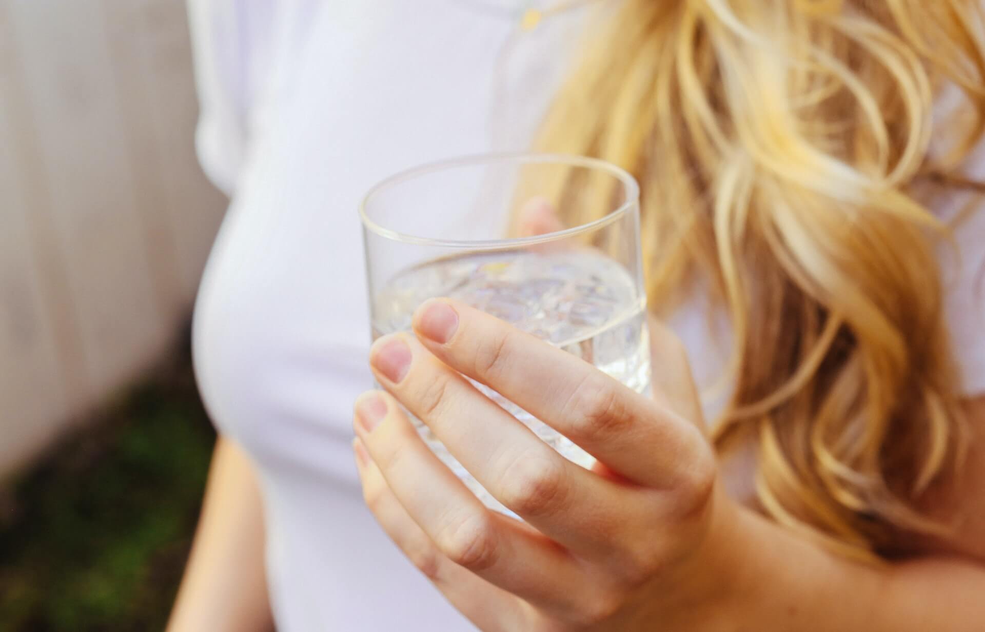 Woman holding glass of water