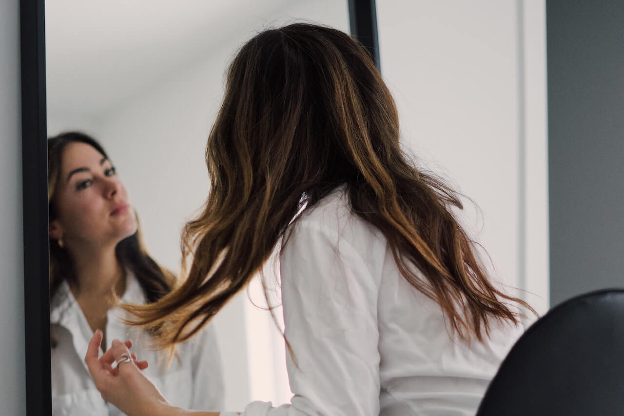 Woman looking at herself in the mirror
