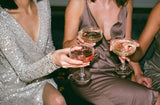 women cheersing drinks at holiday party