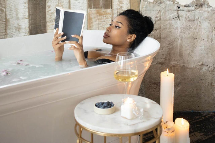 Woman reading a book in a bath
