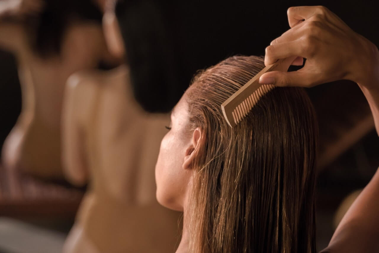 Woman combing hair