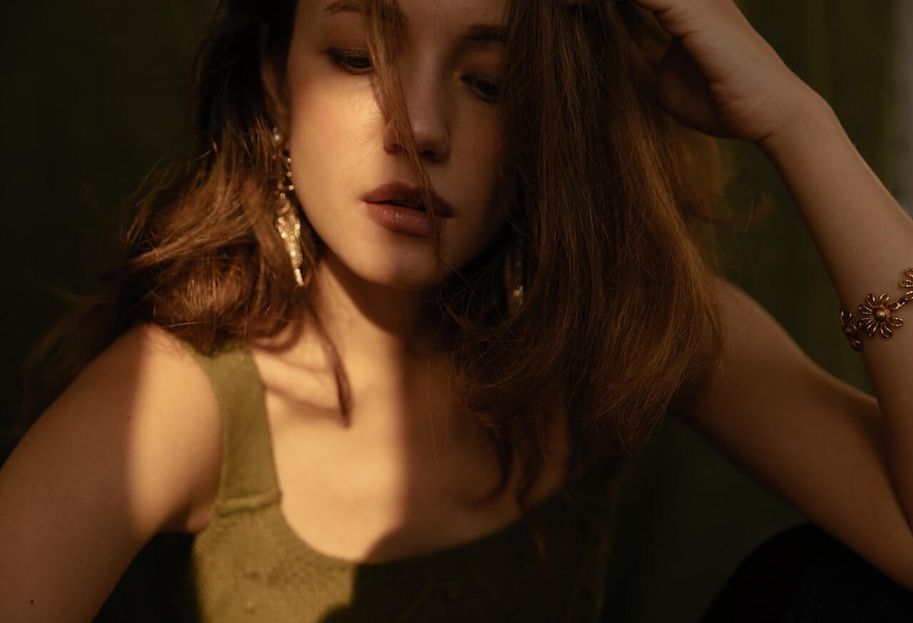 Woman touching her brown hair