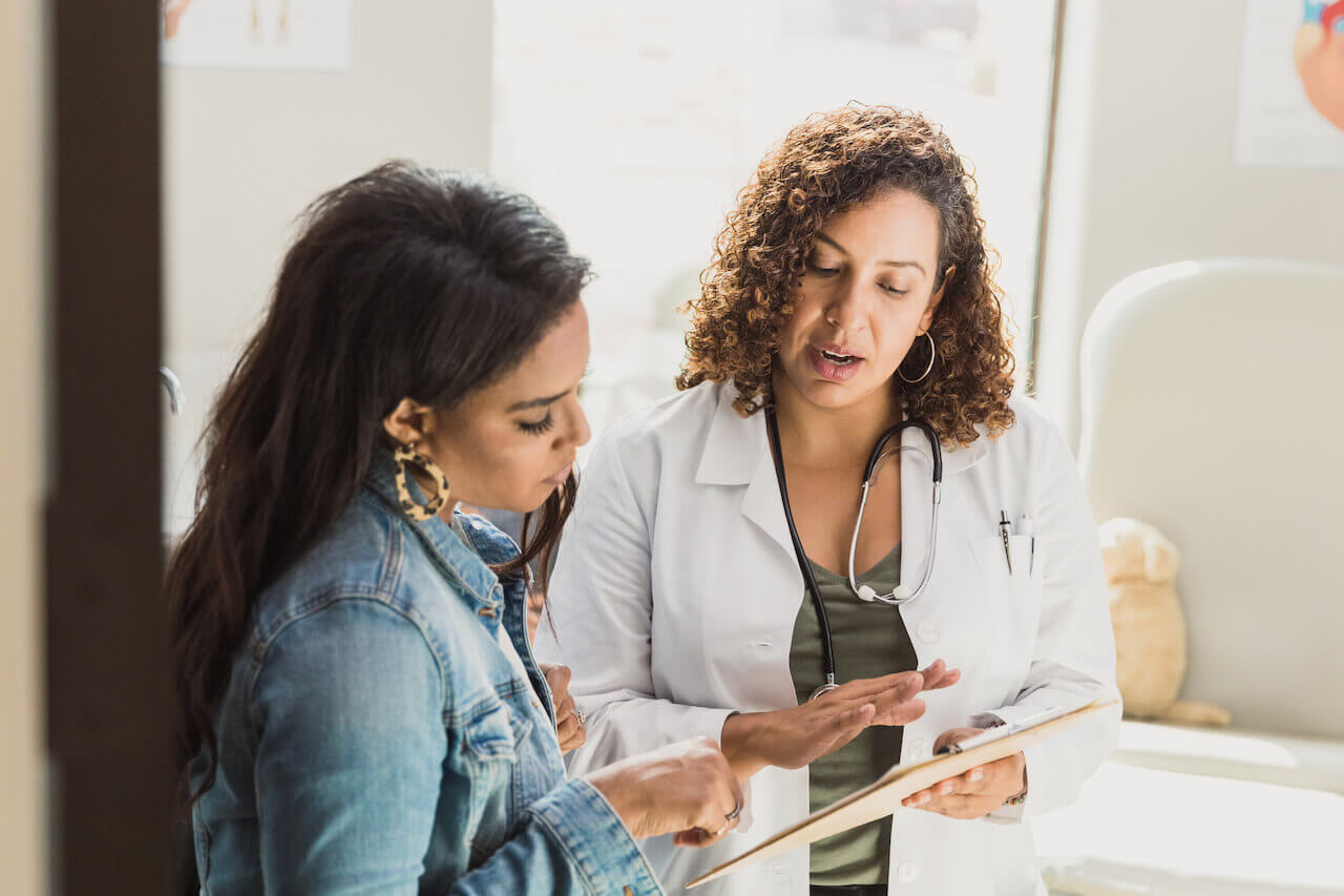 Woman talking to doctor