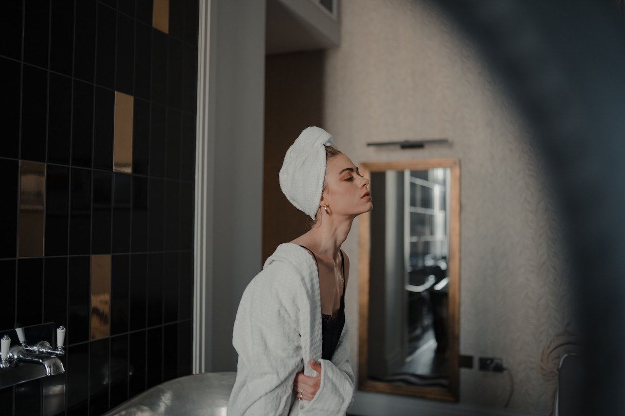 Woman wearing towel and bathrobe