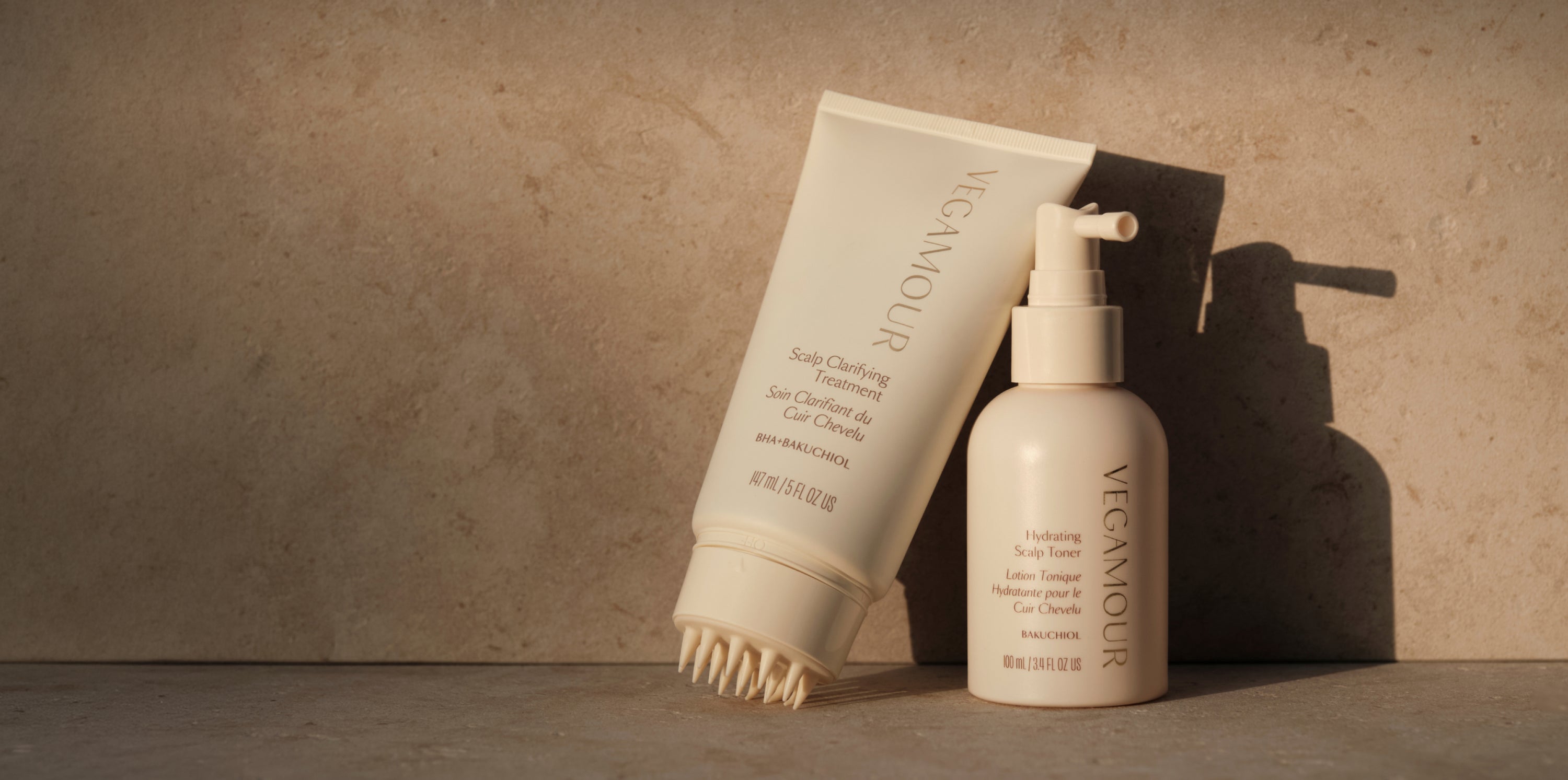 Scalp Clarifying Treatment and Hydrating Scalp Toner on a warm stone surface