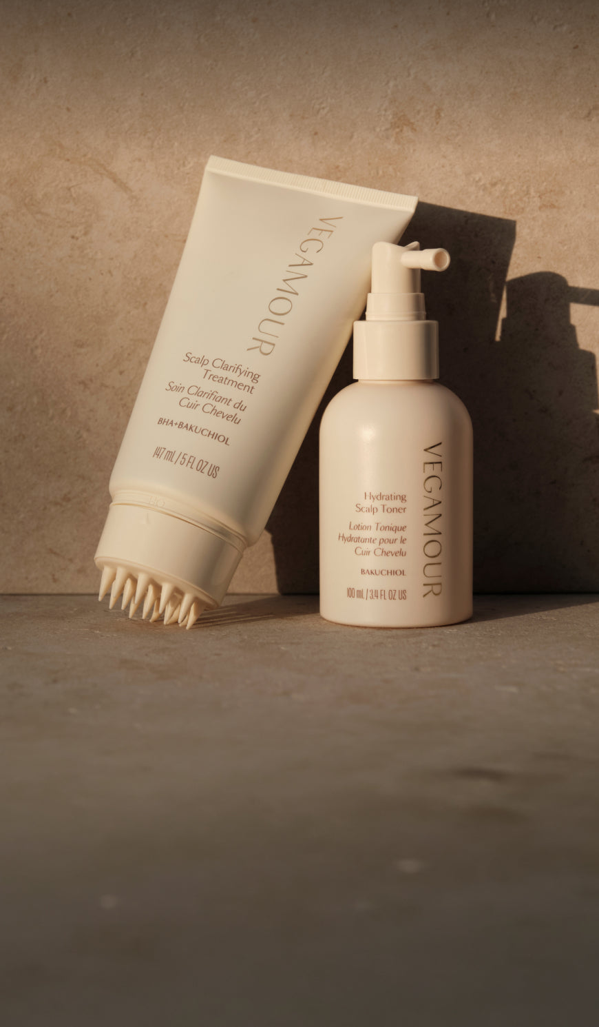 Scalp Clarifying Treatment and Hydrating Scalp Toner on a warm stone surface